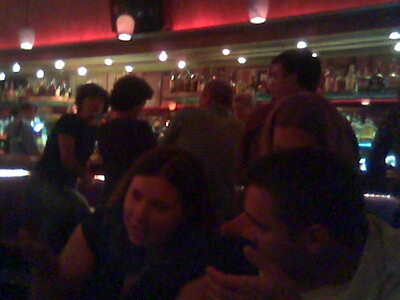 In the foreground are two of the people Erin and I shared a table with. In the background, the bar.