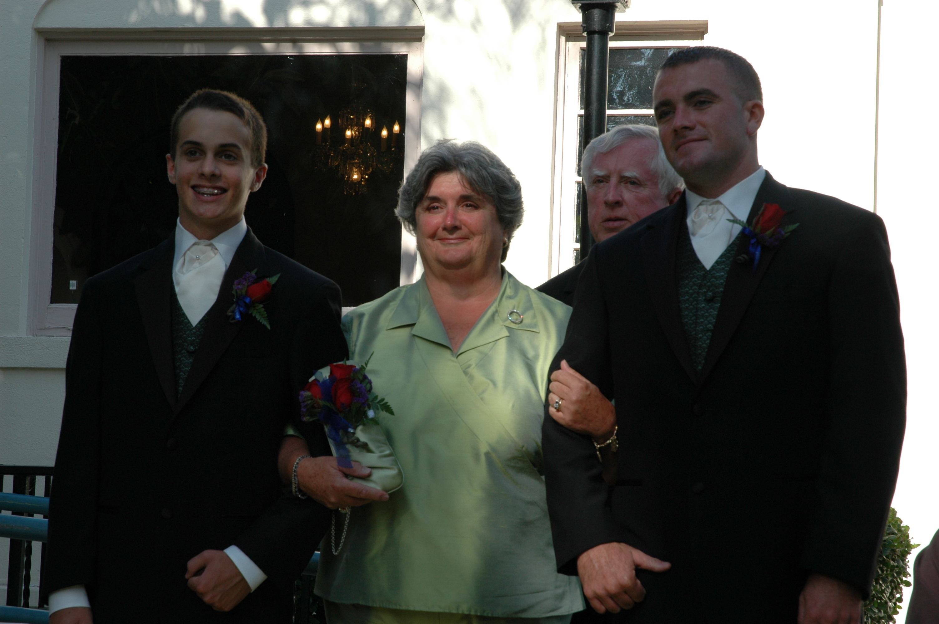 Mom, escorted by Eddie and Billy, with Dad following