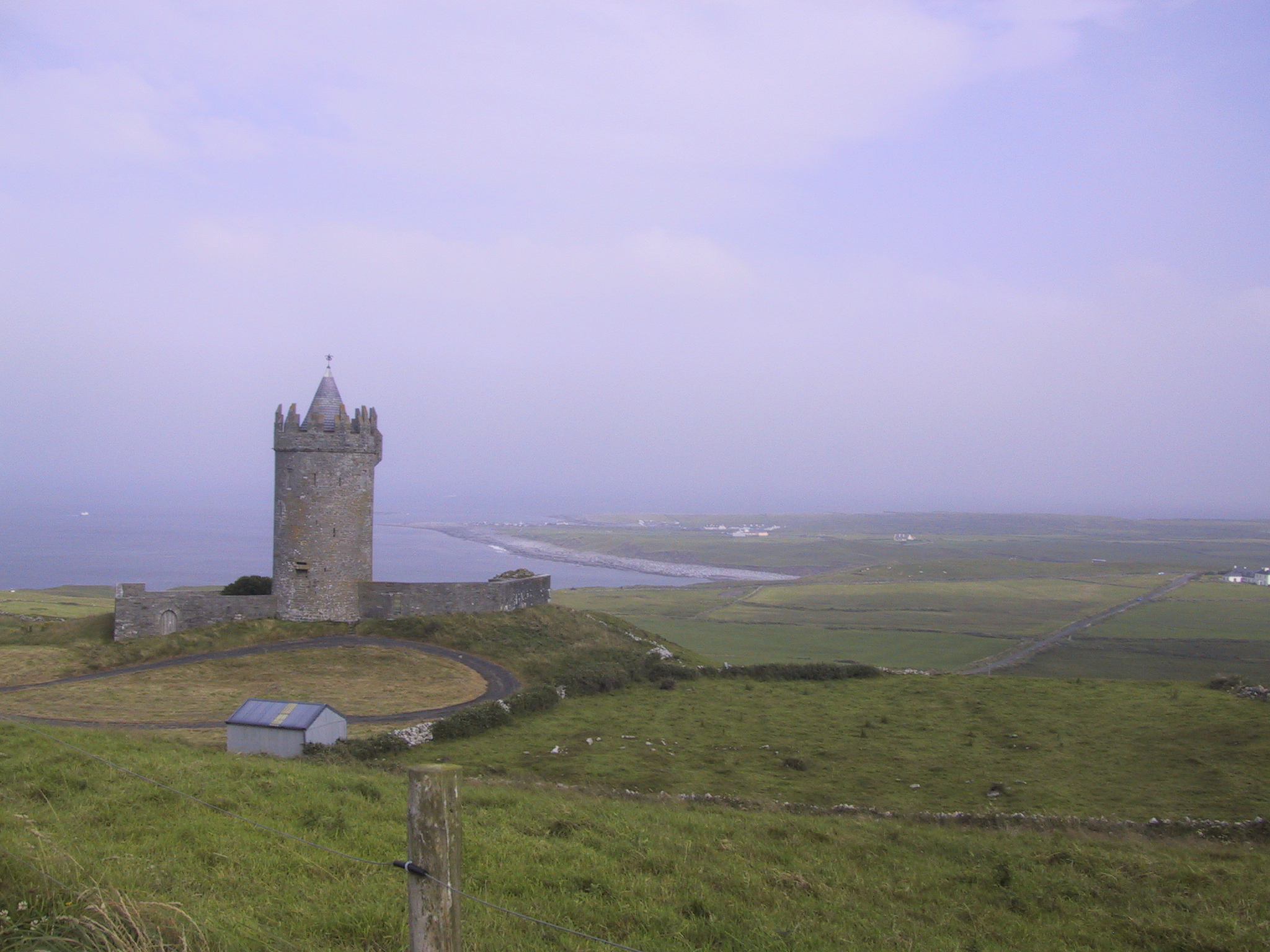 Doonagore Castle of Doolin, Co. Clare, with Doolin Harbor behind