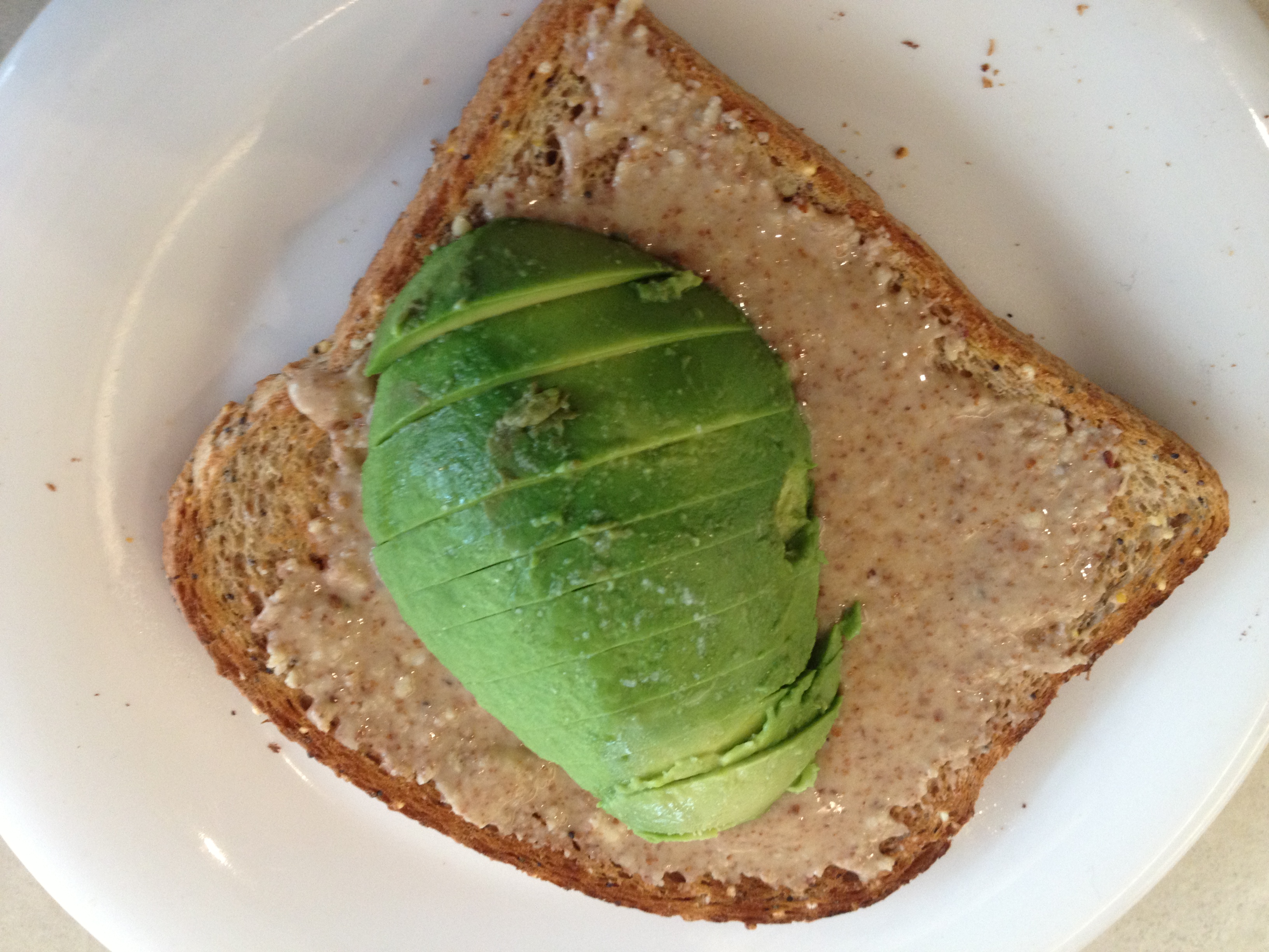 Multigrain bread, almond butter, half an avocado, and sea salt.