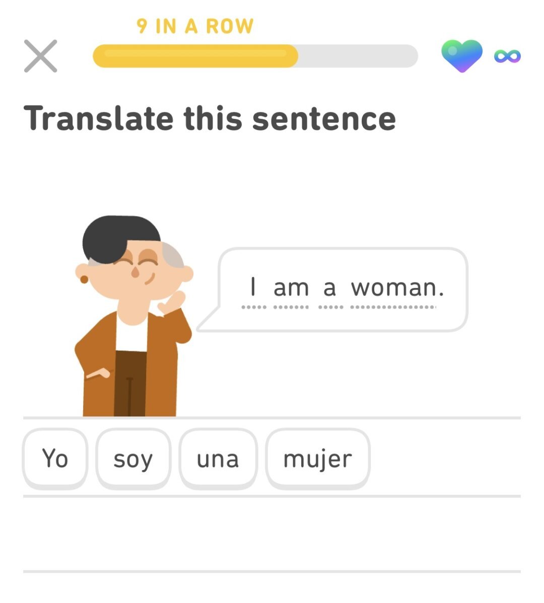 A screenshot of Duolingo, a language-learning app, during a Spanish lesson. The user is prompted to translate the sentence "I am a woman" into Spanish. The user has answered "Yo soy una mujer."