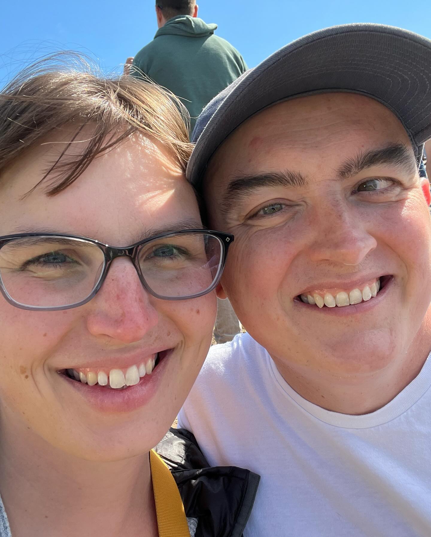 A close shot of Eryn and me smiling at the camera.
We’re outside on a sunny day.