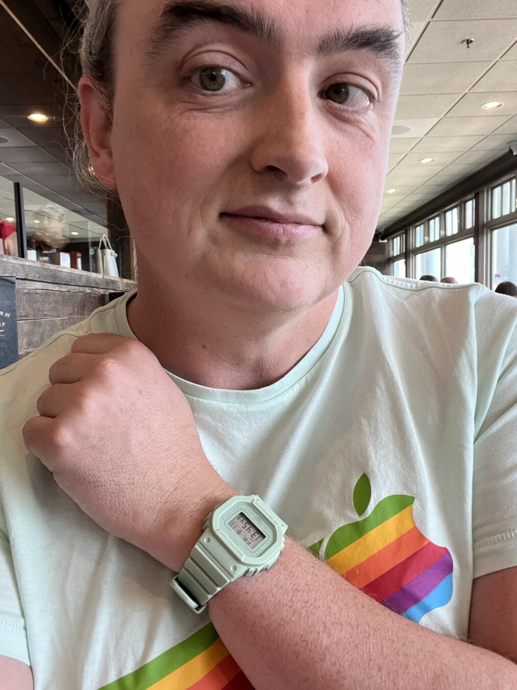 A selfie. I’m wearing a mint green T-shirt with a retro-80s rainbow Apple logo on it, and a matching mint green square G-Shock wristwatch.