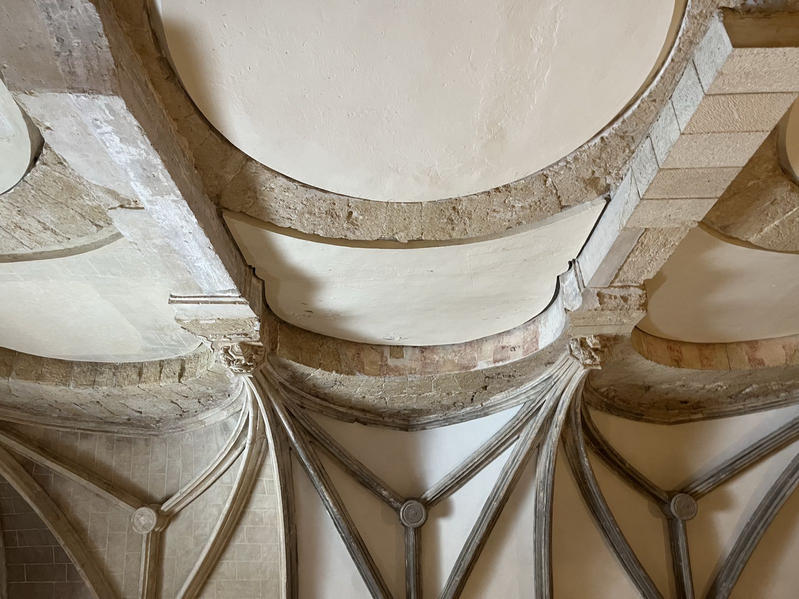 More double arches, but the space between them has been filled to create a wall within the larger structure.