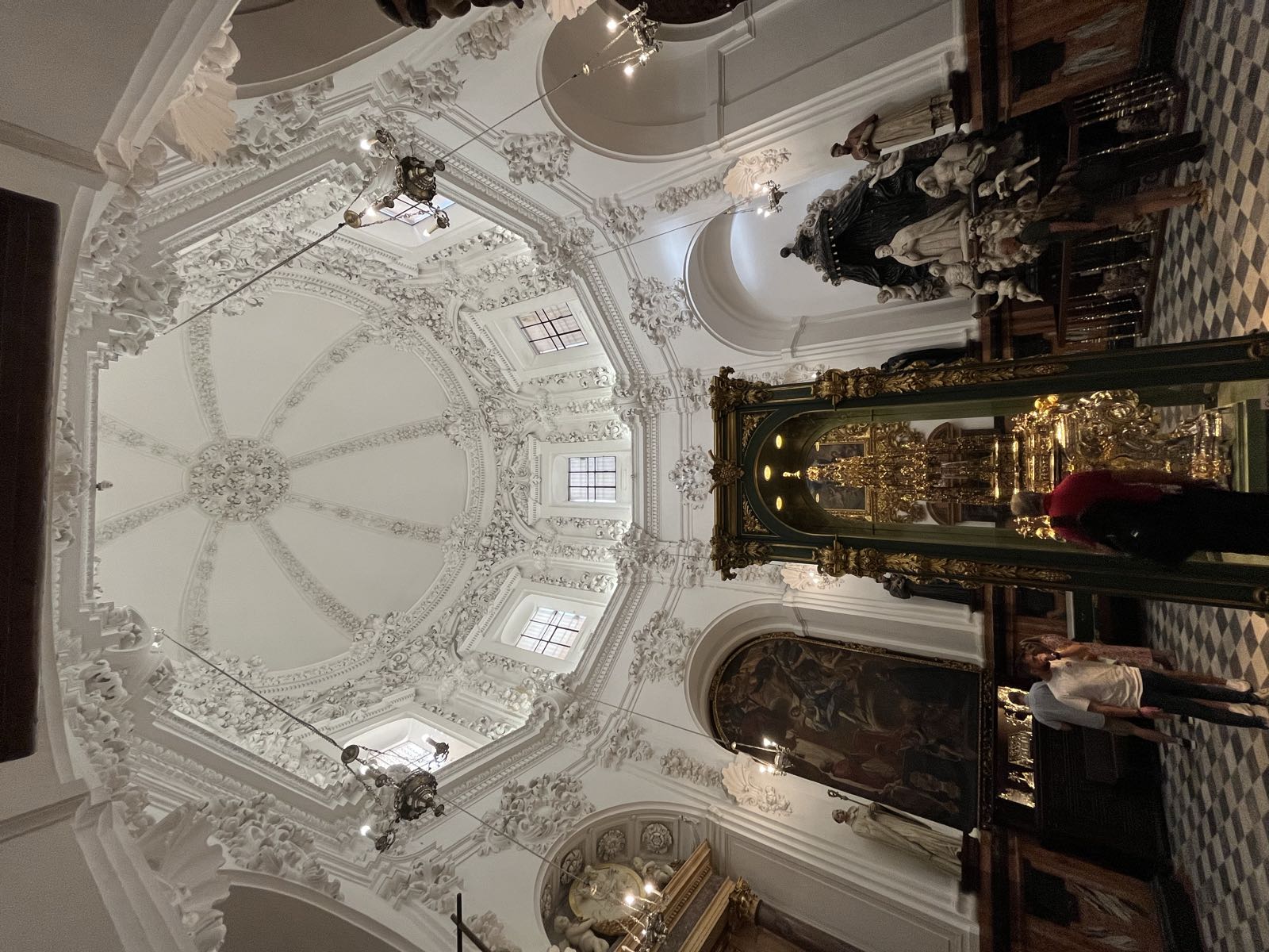 A white, European-style dome above a room filled with Catholic religious items.