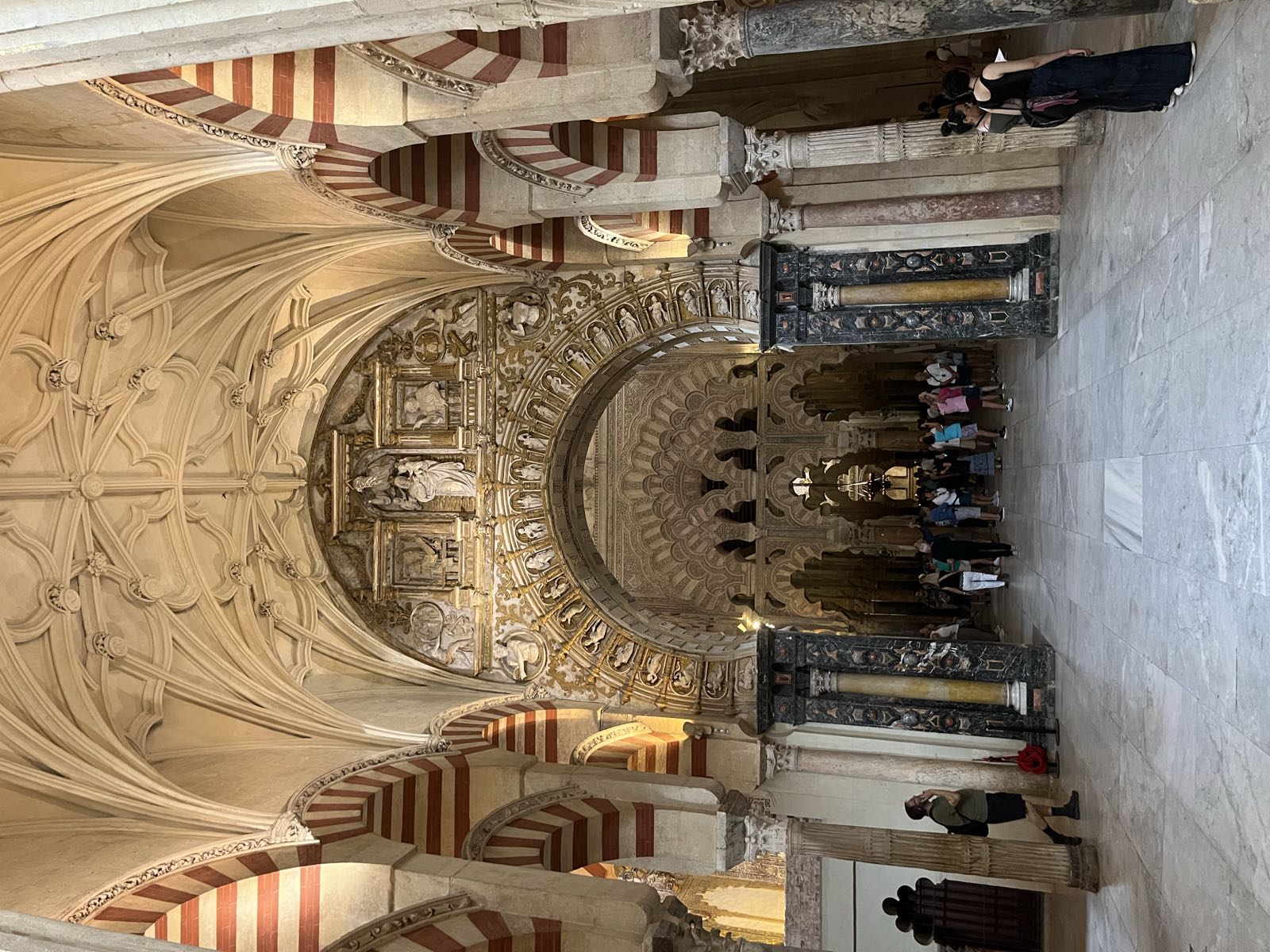 Looking towards the wall with the mihrab from the main cathedral, you can see the different architectural elements of the building at each archway. Visible are some Christian/medieval elements on the nearest archway; beyond it, the ornate Moorish archways of the mihrab.