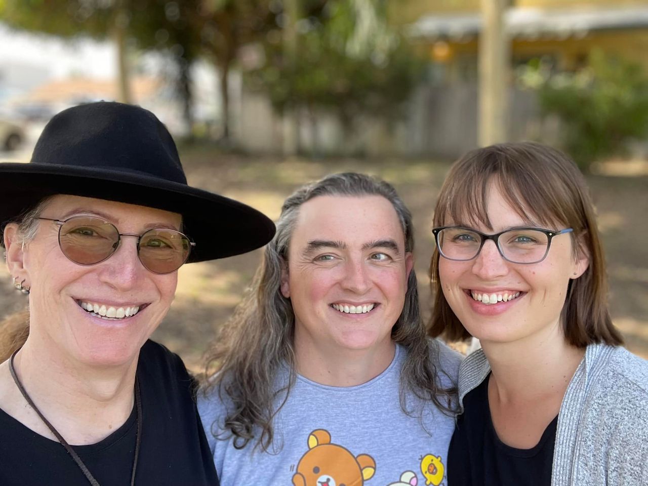 A selfie of three smiling humans: Val on the left, Eryn on the right, and yours truly in the middle.