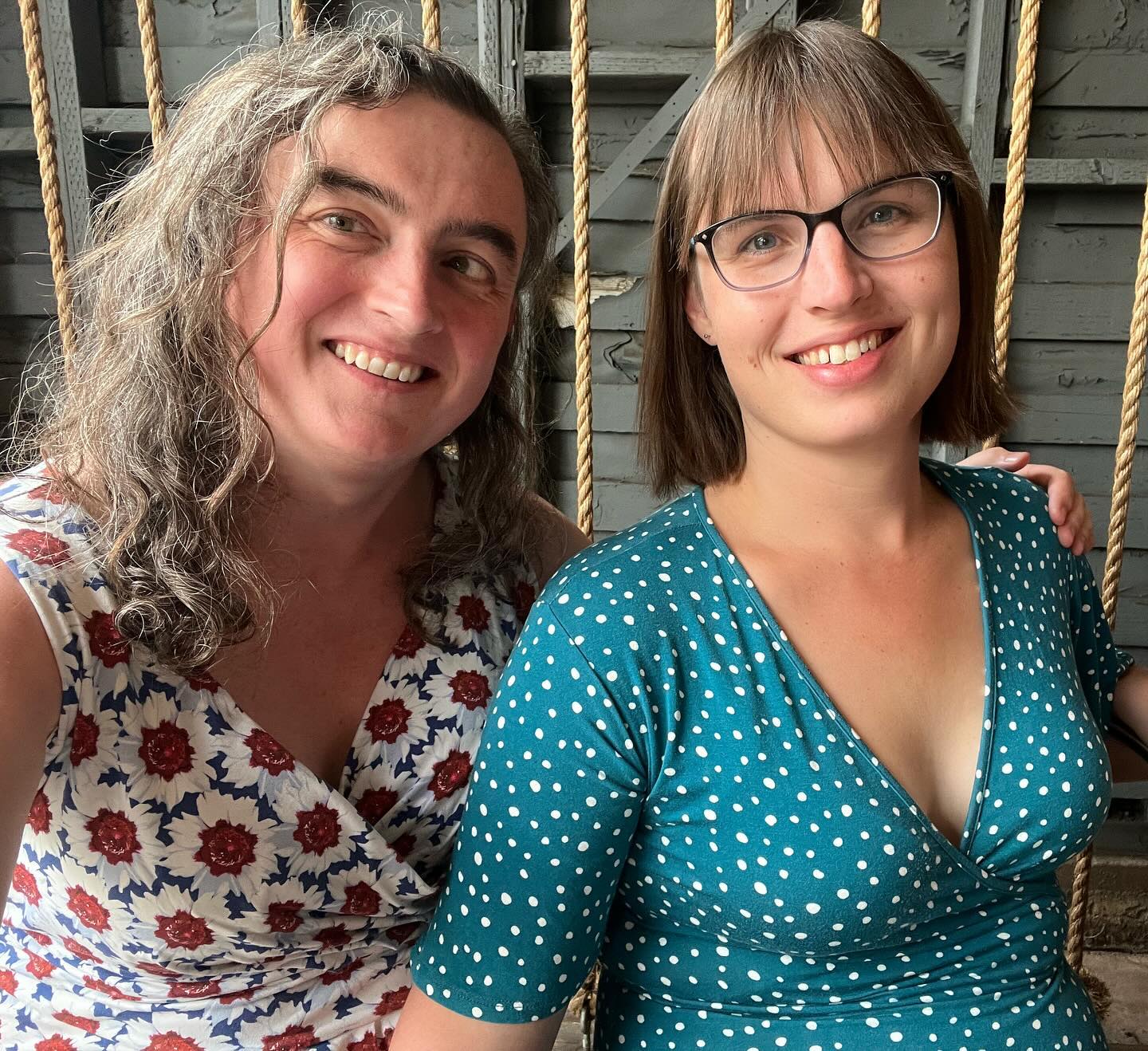 A selfie of Eryn and me.
We’re both in dresses—mine has a red, white, and blue floral pattern, while Eryn’s is green with white polka dots.
We’re both smiling at the camera.