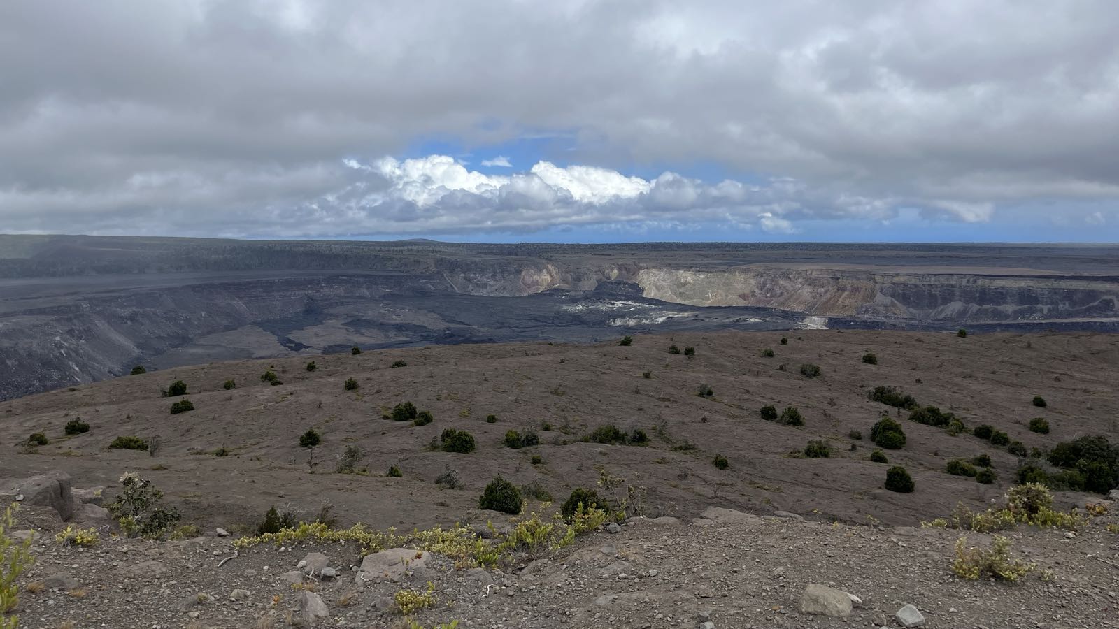 A cloudy sky over a barren landscape.
In the center is the main crater of Kilauea, the most active of Hawaii’s volcanoes.