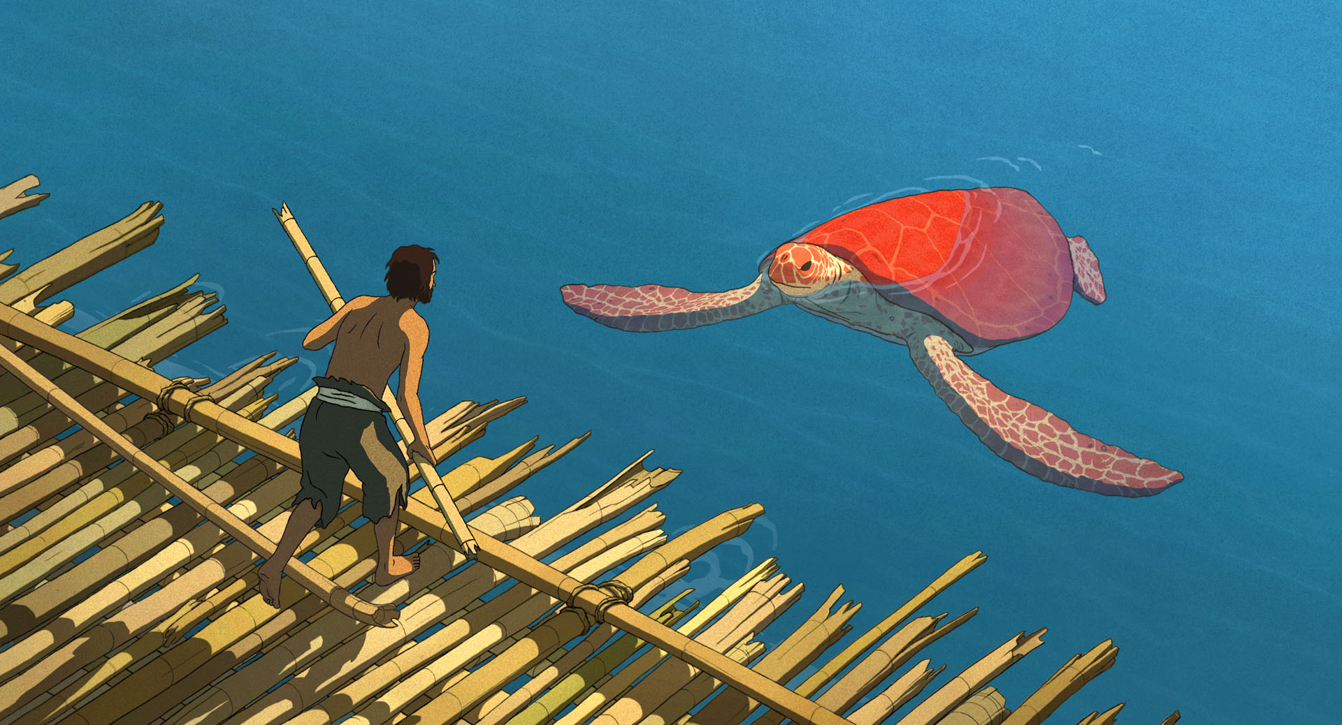 A shirtless man working on a structure made of bamboo is greeted by a giant red turtle.