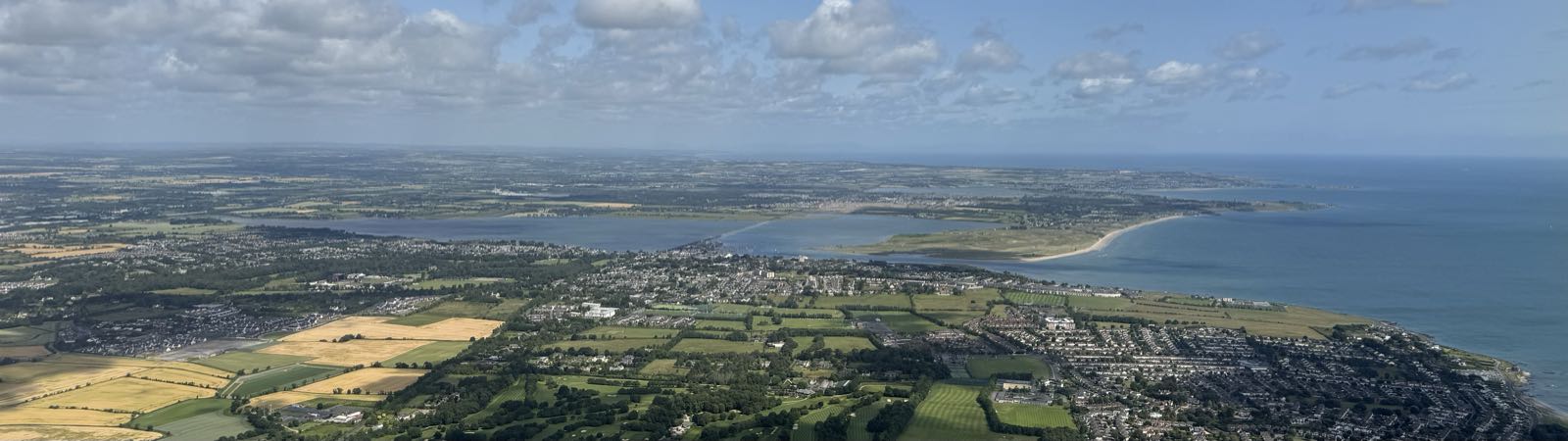 An aerial view of an inhabited area near the coast of a land mass.