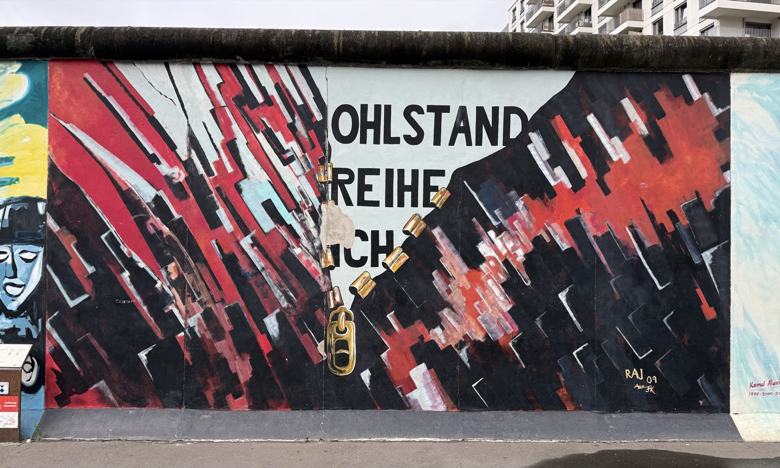 A painting depicts a reality in white, red, and black being pulled apart by a large, gold zipper.