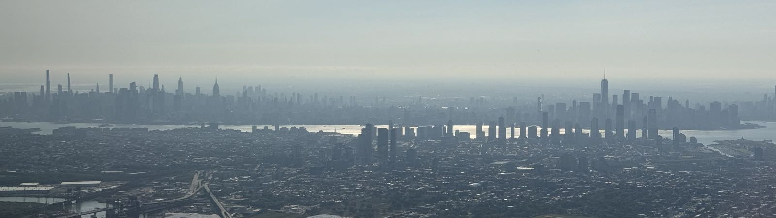 The skyline of New York City on a hazy day from New Jersey airspace.