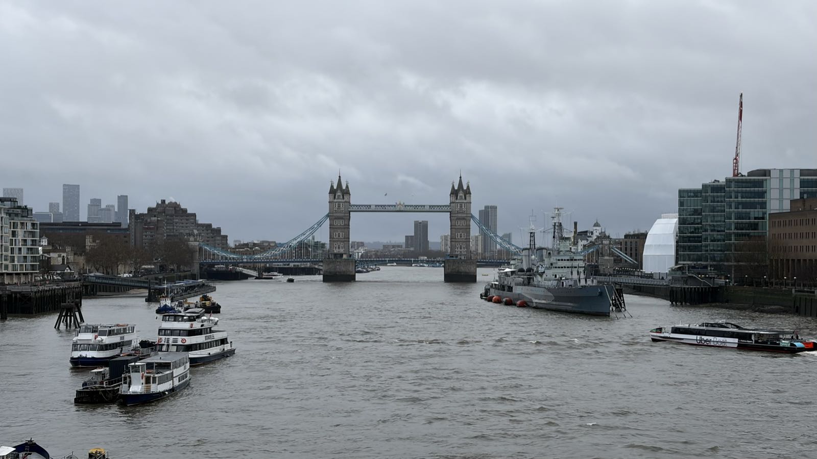 London’s Tower Bridge, spanning the Thames, on a cloudy day.