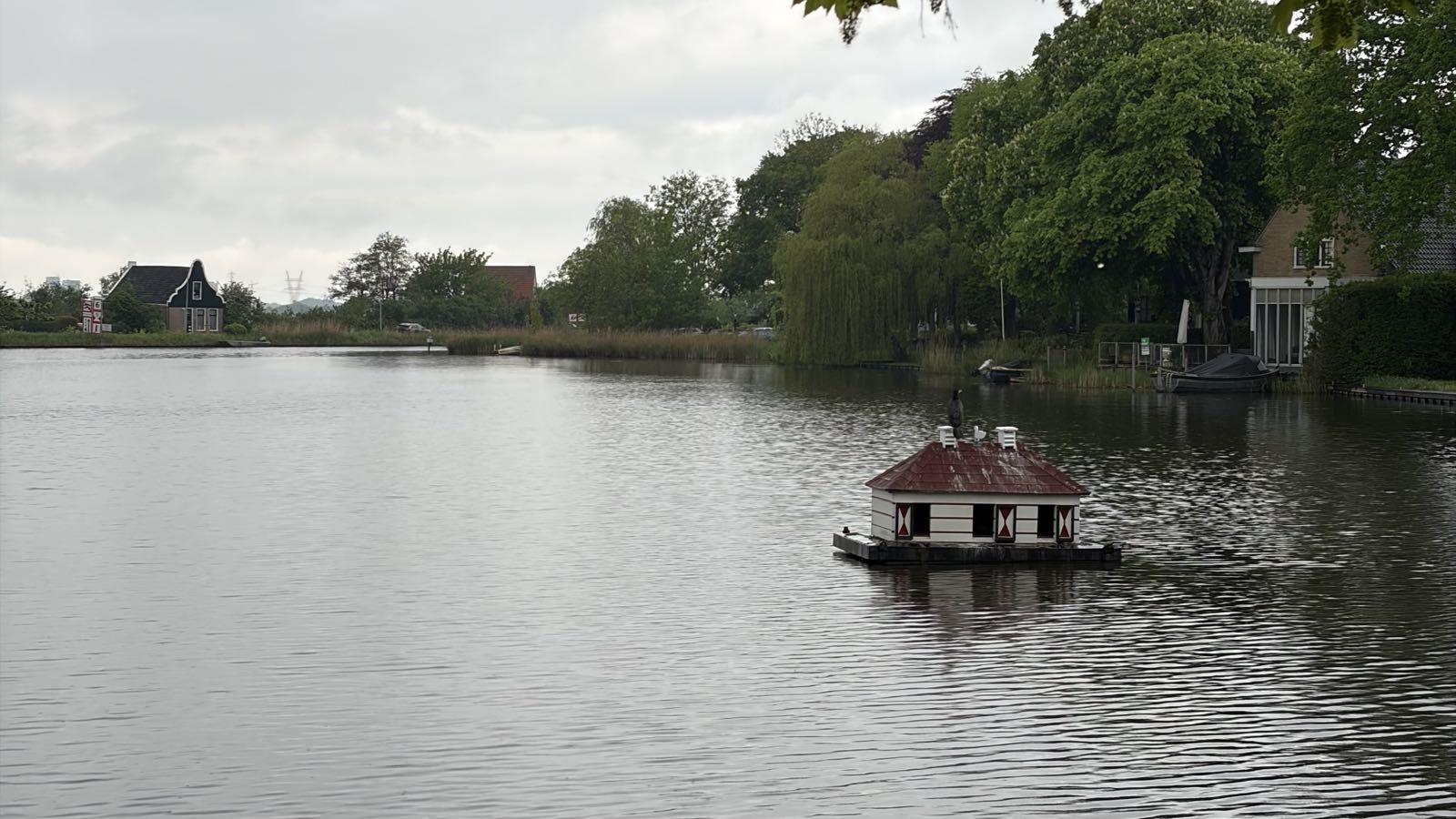 A small building appears to be floating on a lake.