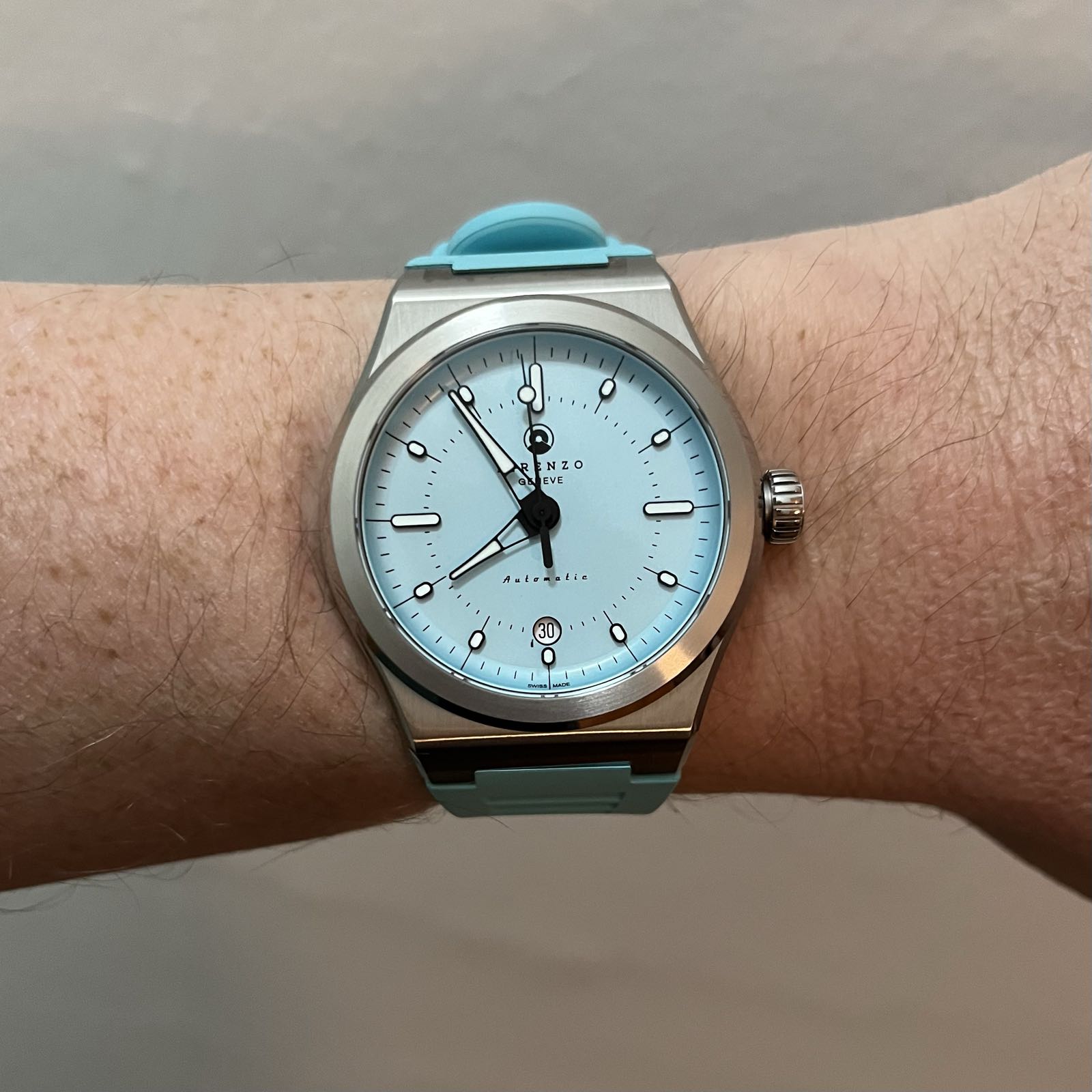 A steel sports watch. It has a baby blue dial and it’s on a matching baby blue rubber strap. There’s a date complication at 6:00.