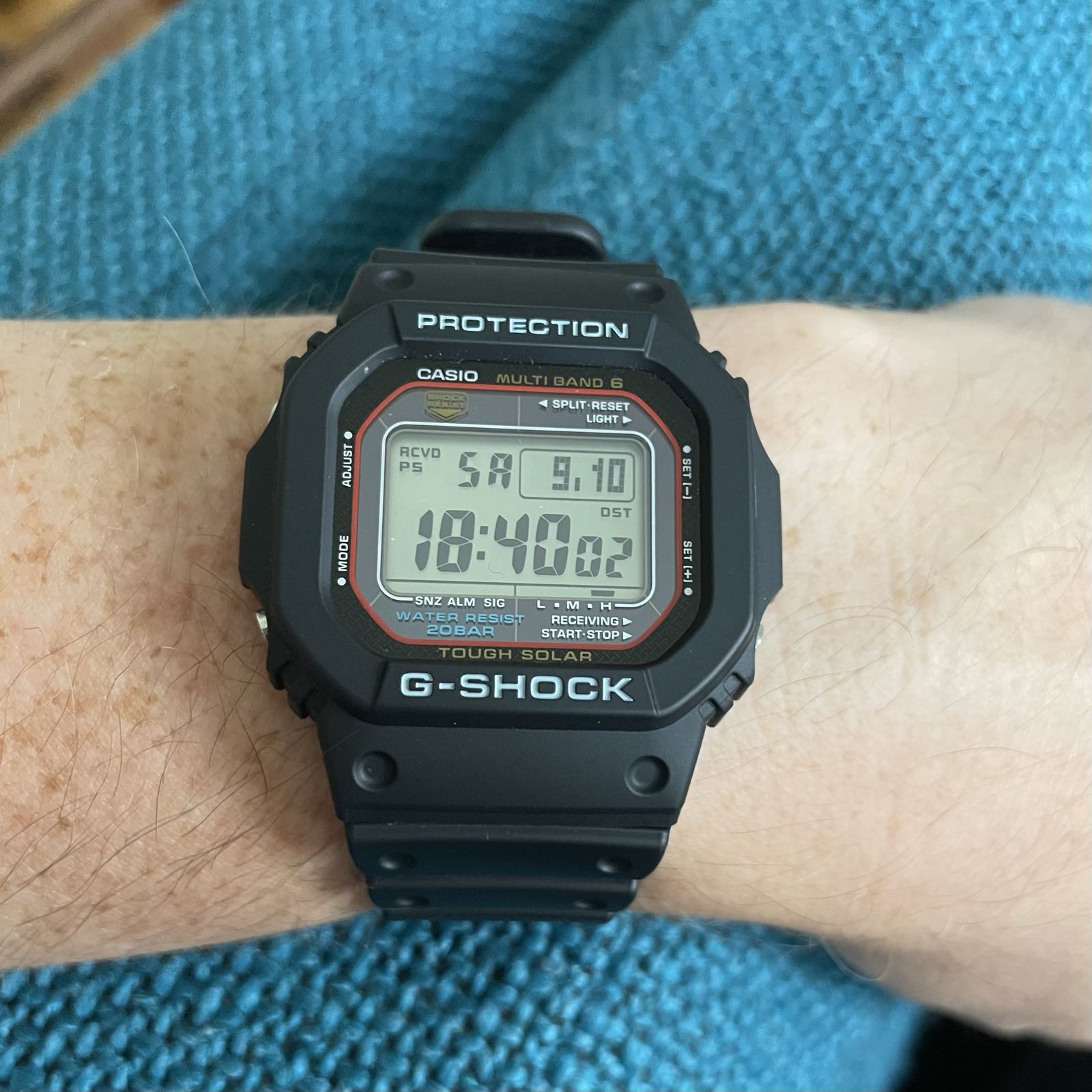 A black plastic digital watch with a black dial surrounding a positive display.